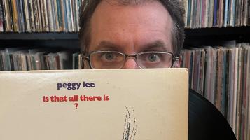 person behind record with glasses on