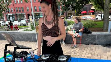 Woman DJing in city hall park