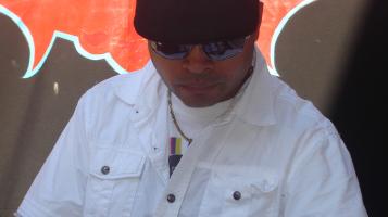 person standing infront of flasg wearing white