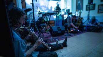 band playing in blue lit room.