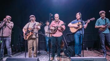 Americana band on stage in a blackbox theatre