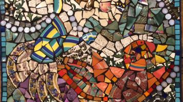 Colorful ceramic mosaic depicting a woman riding upon a bird. 