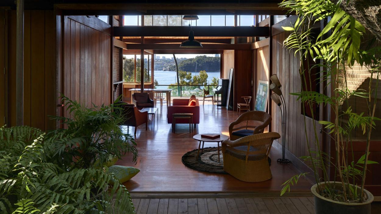 A contemporary home frames an architectural view of a bay of water