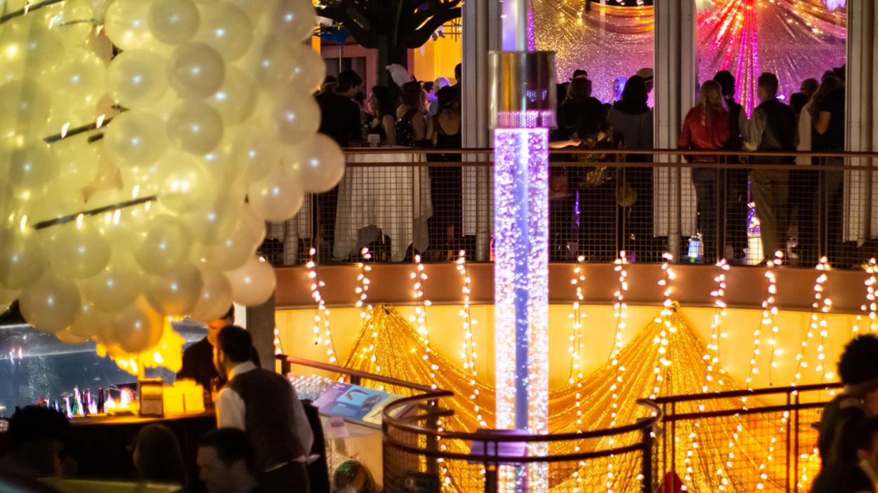 patrons enjoying a glamorous New Year's Eve party inside a decorated Echo Leahy Center