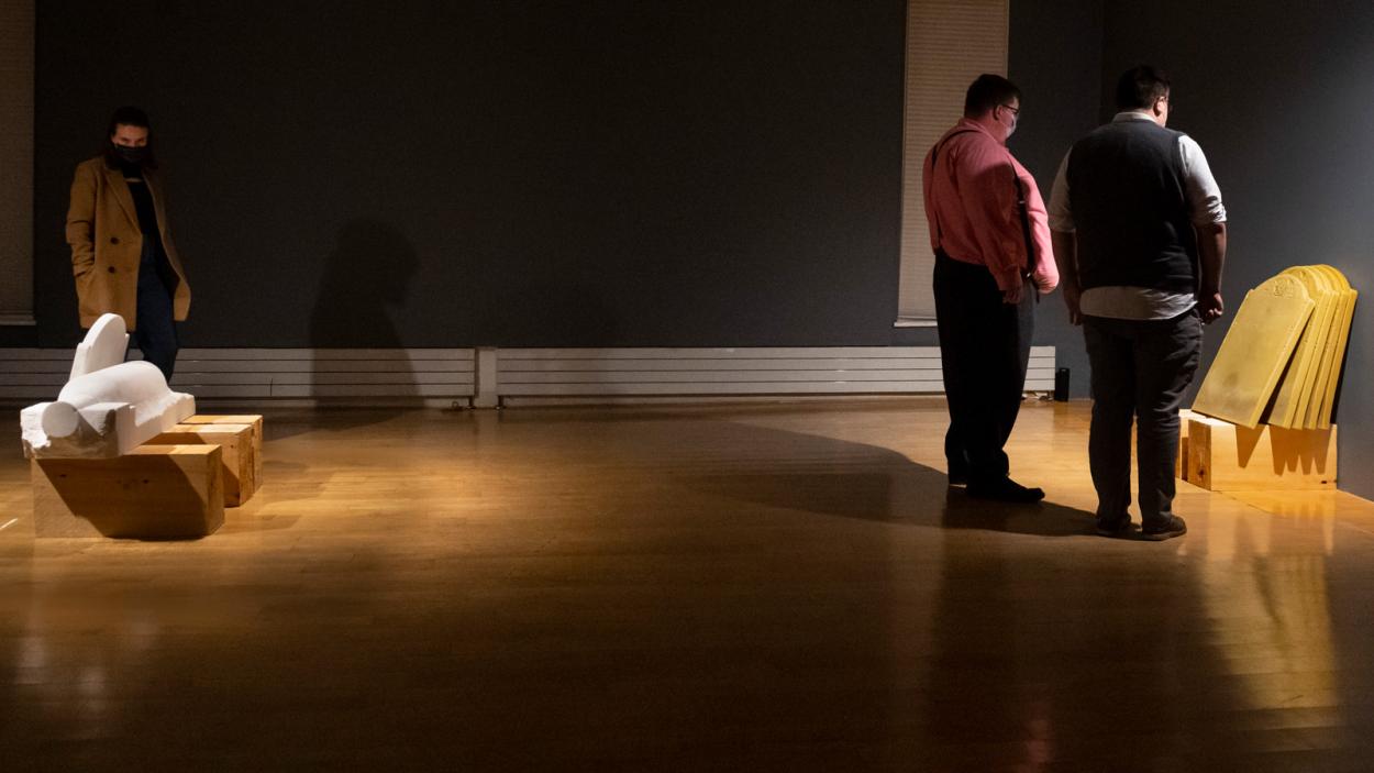 Objects of Empire BCA Center installation with people in gallery viewing marble carvings and beeswax castings