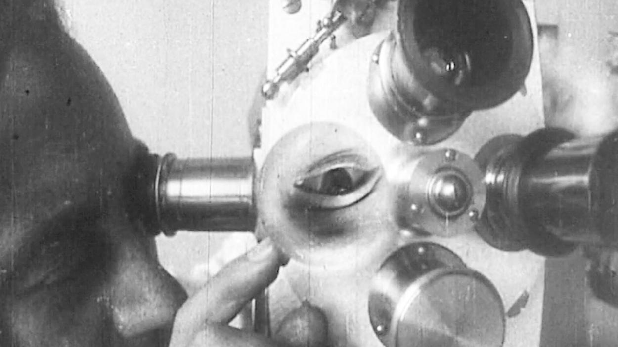 A black and white surrealist photograph of kaleidoscopic images of a man looking through a telescope, eyes, and the telescope from different angles