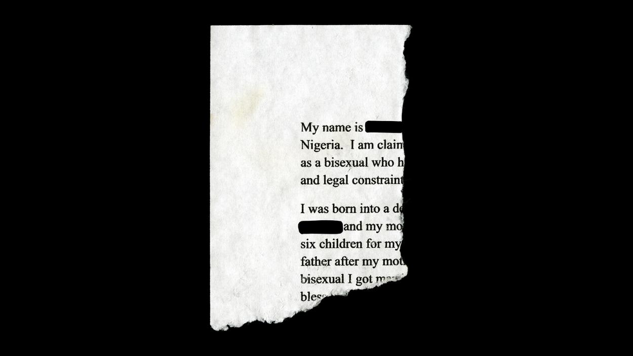 A photograph of the torn off corner of a document that says "My name is Nigeria. I am claim as a bisexual who h and legal constrain I was born into a de and my mo six children for my father after my mot bisexual I got noc bless." Words are both cut off by the tear, and redacted with black lines.