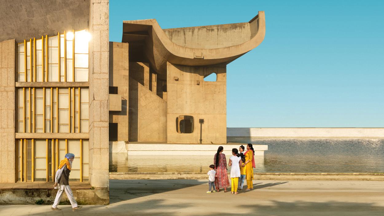 An image of people juxtaposed by uniquely designed buildings.