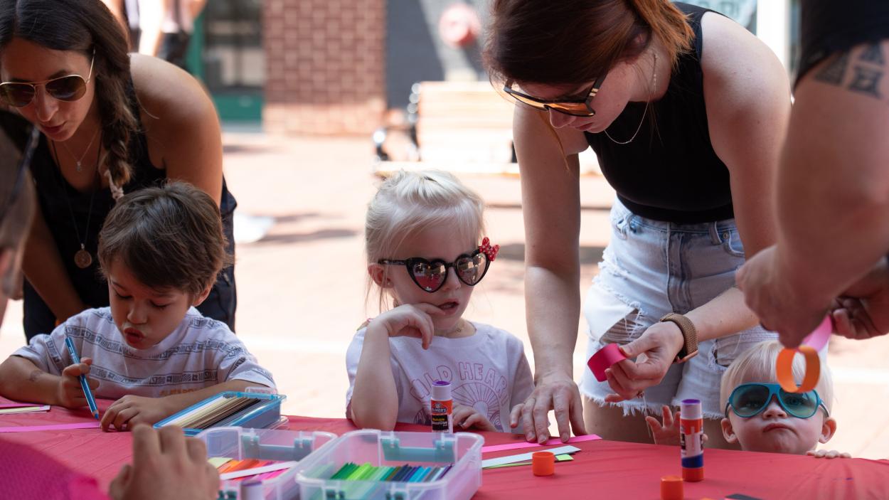 kiddos making art with sunglasses on outside.