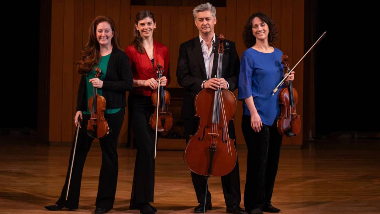 4 People on a stage with instruments