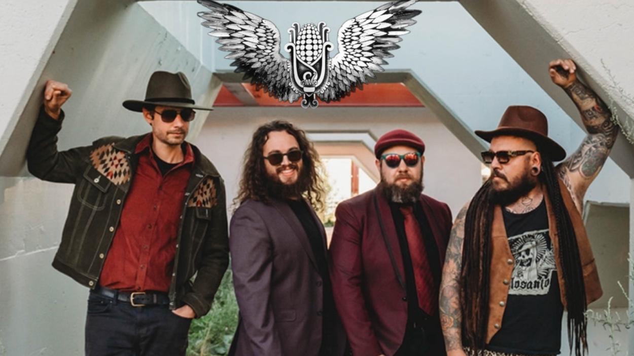 A press image for Mal Maiz's band standing in an arched doorway
