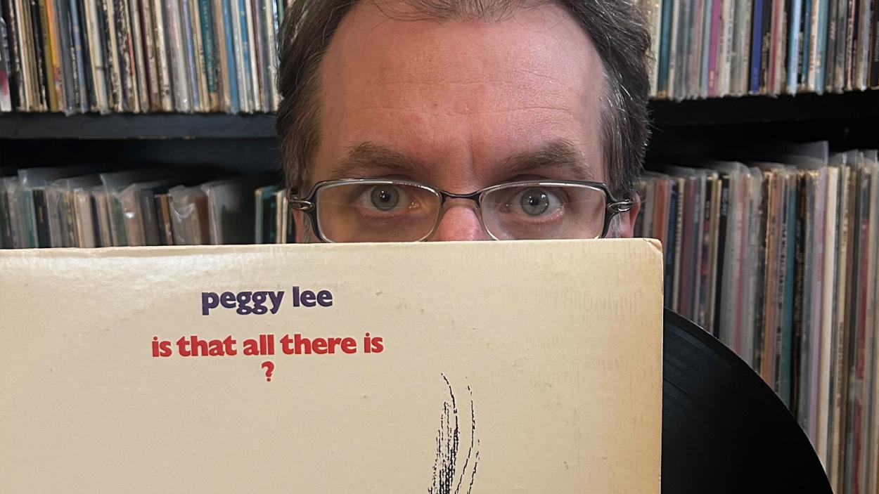 person behind record with glasses on
