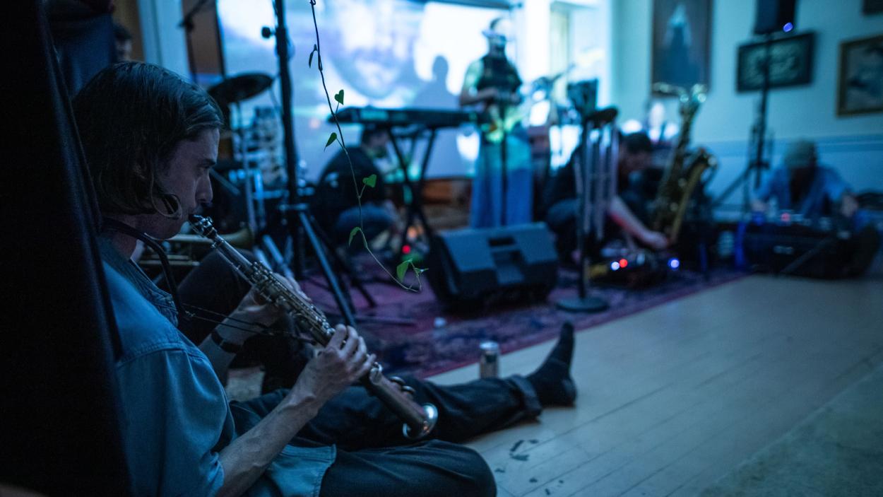 band playing in blue lit room.