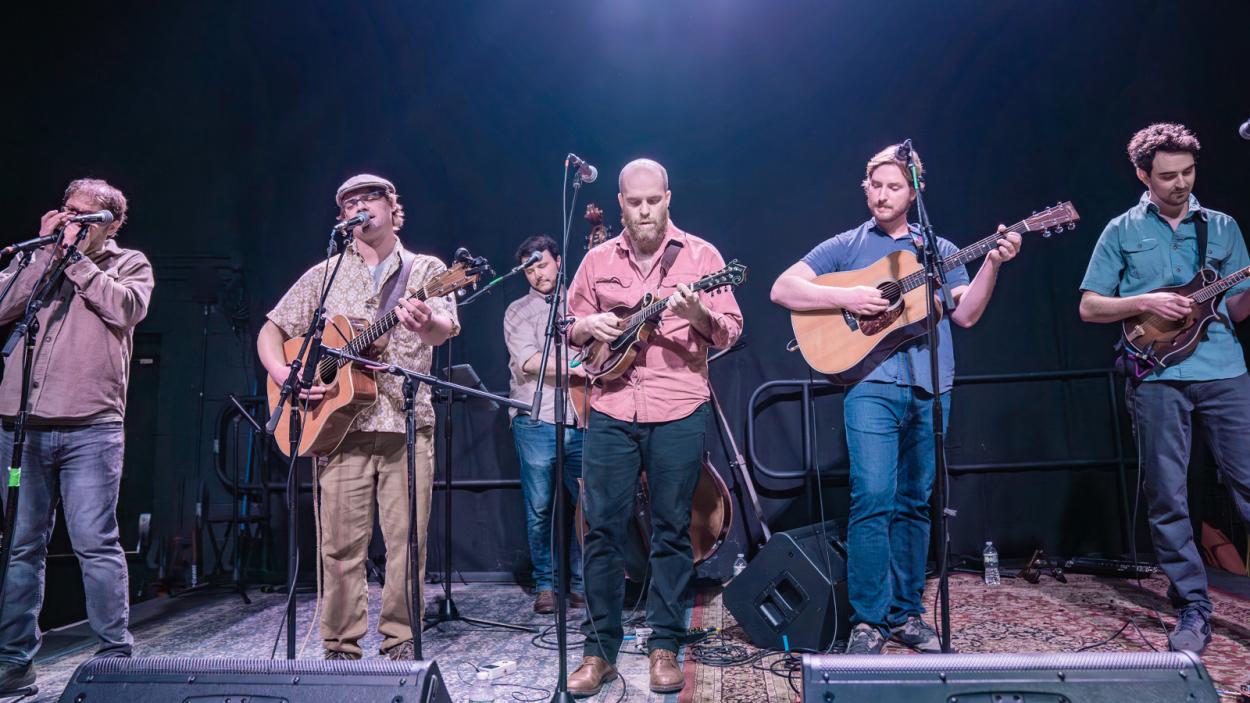 Americana band on stage in a blackbox theatre