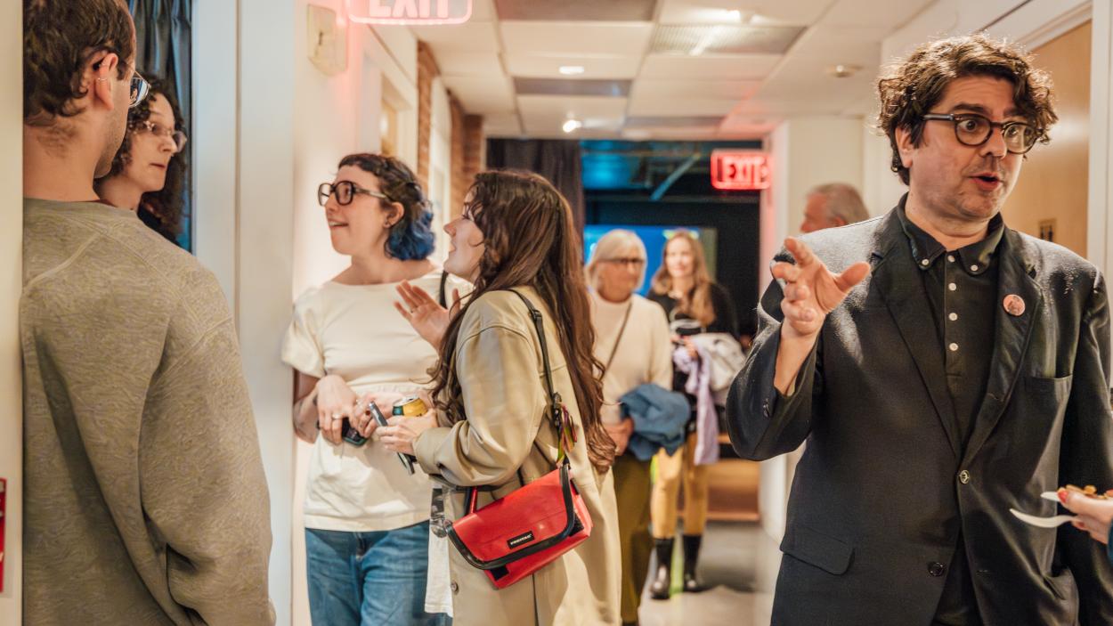 people in the second floor hallway of the bca center during an art opening