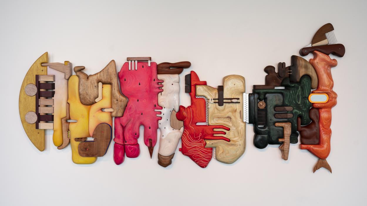 A photo of Cathy Della Lucia's mixed media sculpture "Grocery Conveyor", 2024