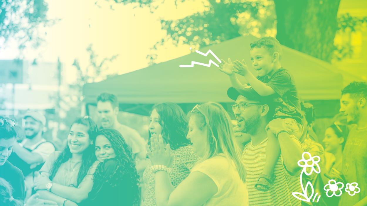 a stylized photo of people cheering at an outdoor concert with a wash of green and yellow over it