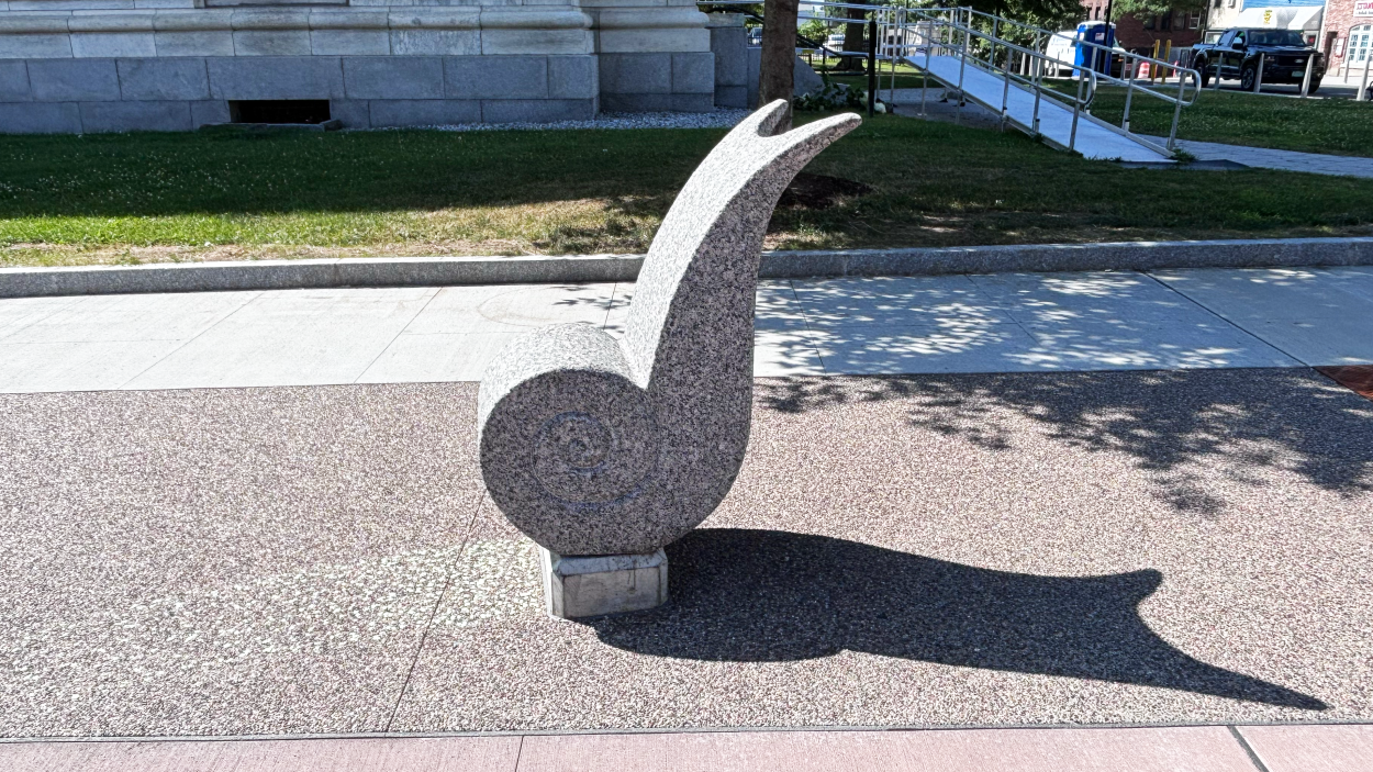 a photograph of Magnus, a statue of a stone snail