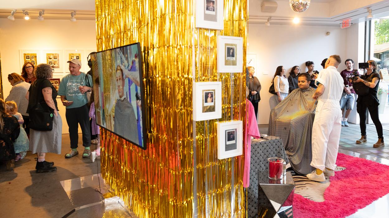 Artist Ace Lehner performing a live hair cut  during an artist reception at the BCA Center, a Contempoary Art Center
